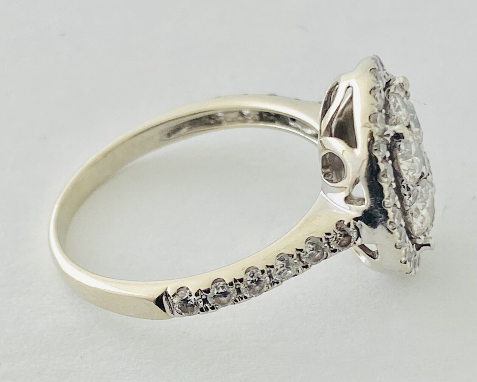 14kt White Gold , Round Diamonds Forming An Oval Shape With Pave Halo