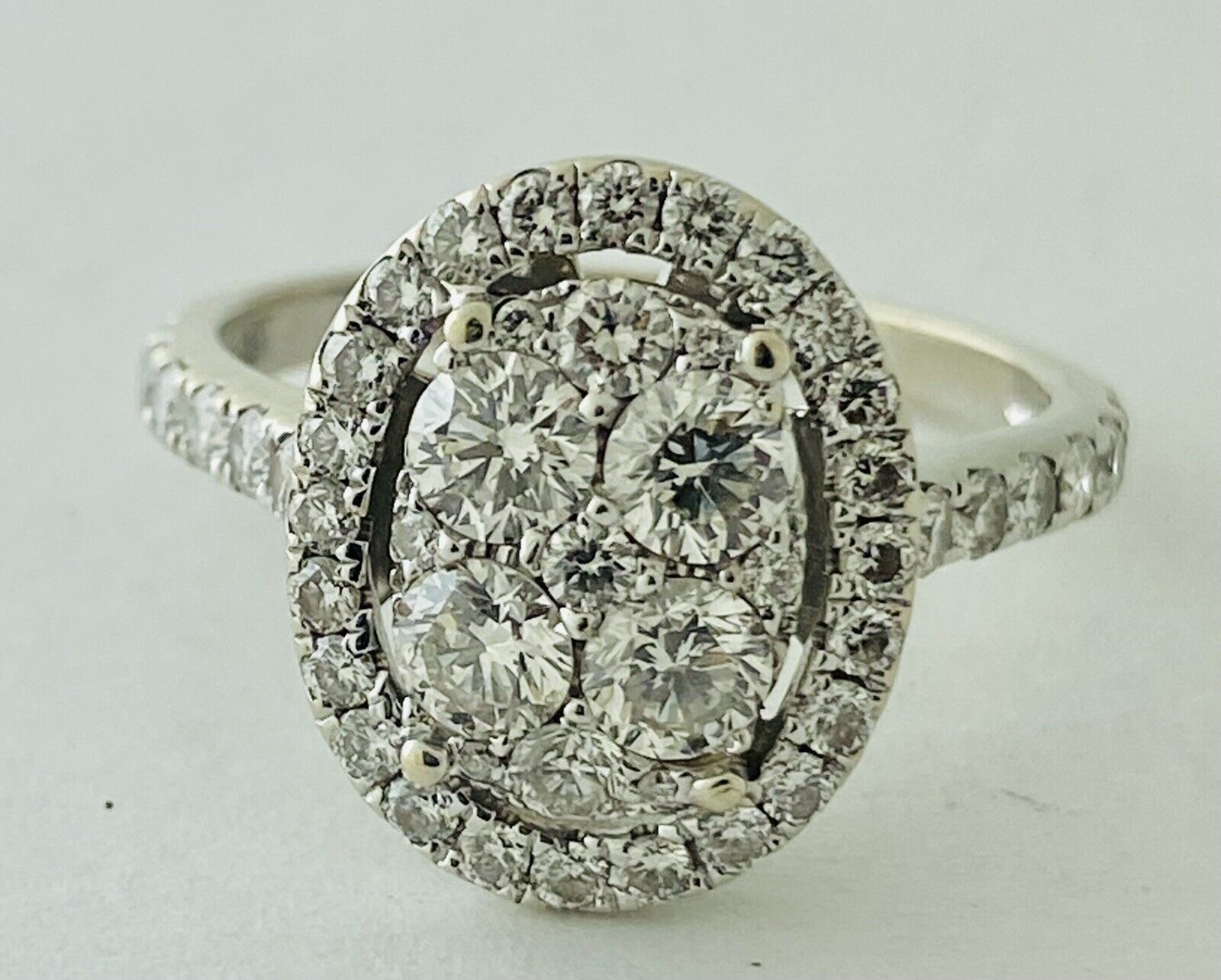 14kt White Gold , Round Diamonds Forming An Oval Shape With Pave Halo